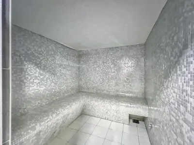 an empty bathroom with white tiles on the walls at The Smart Concierge - DEC Tower in Dubai