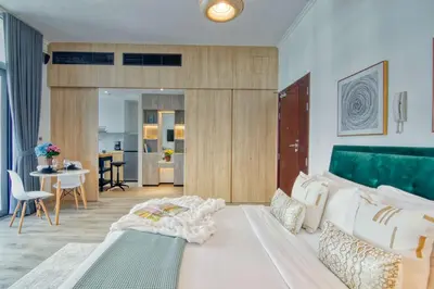 a bedroom with a bed and a living room at The Smart Concierge - DEC Tower in Dubai