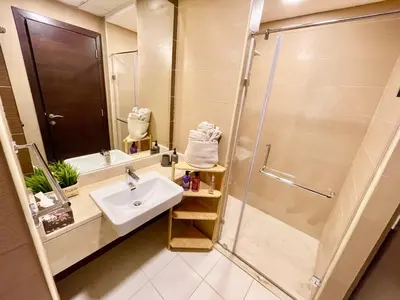 a bathroom with a sink and a shower at Super Elegant studio apartment-Sparkle tower By SWEET HOMES in Dubai