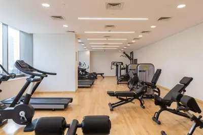 a gym with several treadmills and exercise bikes at The Smart Concierge - Sparkle tower in Dubai