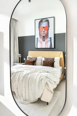 a bedroom with a large bed in a mirror at The Smart Concierge - Beach Vista Tower in Dubai