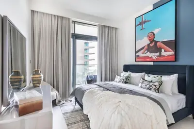 a bedroom with a bed and a large window at The Smart Concierge - Beach Vista Tower in Dubai