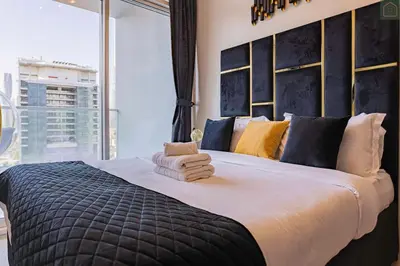 a bedroom with a large bed with a large window at ONYX - Full Burj Khalifa View Dubai 2 BEDROOM APARTMENT - DOWNTOWN DUBAI in Dubai
