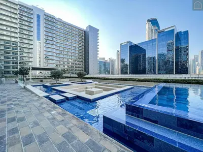 a large swimming pool in a city with tall buildings at ONYX - Full Burj Khalifa View Dubai 2 BEDROOM APARTMENT - DOWNTOWN DUBAI in Dubai