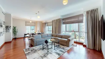 a living room with a couch and a table at Stylish 2-Bed Apt Burj Khalifa and Fountain Views in Dubai
