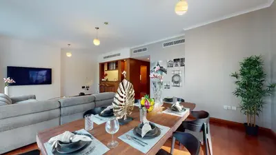 a living room with a couch and a table at Stylish 2-Bed Apt Burj Khalifa and Fountain Views in Dubai