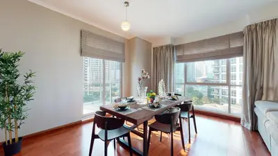 a dining room with a table and chairs and large windows at Stylish 2-Bed Apt Burj Khalifa and Fountain Views in Dubai