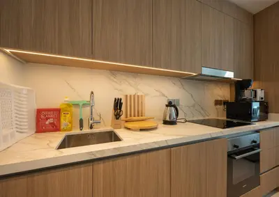 a kitchen counter with a sink and a microwave at Emaar Beach Vista Tower 1 2BHK FAHH in Dubai