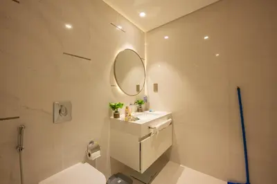 a bathroom with a toilet and a sink and a mirror at Emaar Beach Vista Tower 1 2BHK FAHH in Dubai