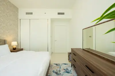 a bedroom with a large bed and a large mirror at Emaar Beach Vista Tower 1 2BHK FAHH in Dubai