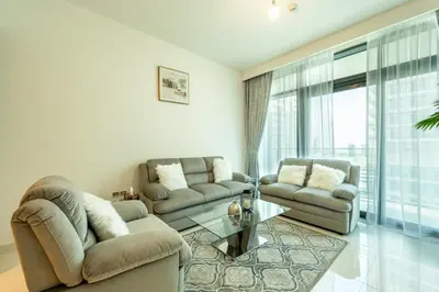 a living room with two couches and a glass table at Emaar Beach Vista Tower 1 2BHK FAHH in Dubai