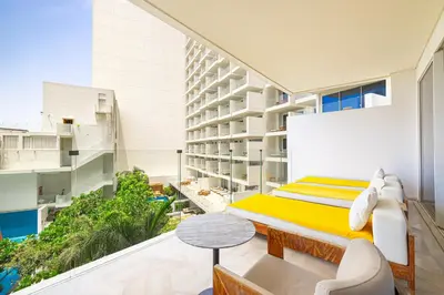 a bedroom with a bed on a balcony at Daniels Five Palm 2BR with Garden View in Dubai