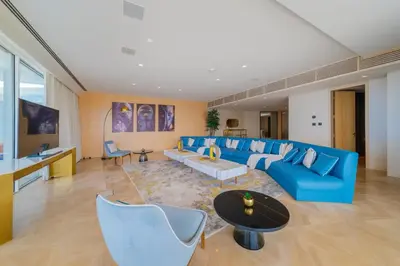 a large living room with blue couches and a table at EDEN'S Homes & Villas - FIVE Palm Residences Penthouses in Dubai