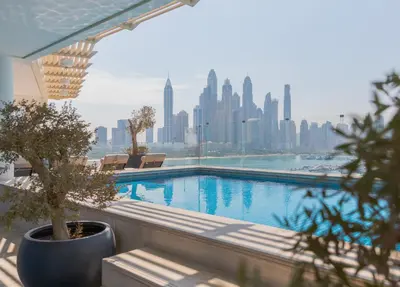 a swimming pool with a view of a city skyline at EDEN'S Homes & Villas - FIVE Palm Residences Penthouses in Dubai
