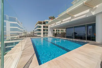 a swimming pool on the roof of a building at EDEN'S Homes & Villas - FIVE Palm Residences Penthouses in Dubai