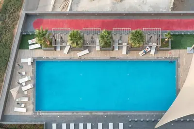 an overhead view of a swimming pool on top of a building at Nice Studio in JVC - Pool & Gym in Dubai