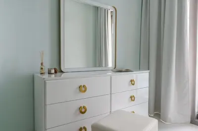 a bathroom with a white dresser with a mirror at GuestReady - Fabulous 2BR with Burj Khalifa view in Dubai