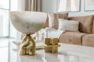a white and gold vase on a table in a living room at GuestReady - Fabulous 2BR with Burj Khalifa view in Dubai