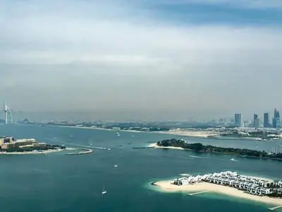 an island in a body of water with a city at Studio Apartment in The Palm Tower 5 Star Facilities in Dubai