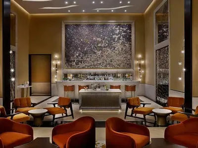 a lobby with a bar and chairs and a painting at Studio Apartment in The Palm Tower 5 Star Facilities in Dubai