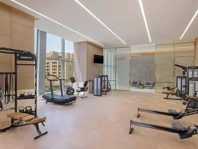 a gym with several treadmills and machines in a building at Studio Apartment in The Palm Tower 5 Star Facilities in Dubai