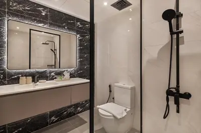 a bathroom with a toilet and a sink and a mirror at Luxury studio in Discovery Gardens near metro in Dubai