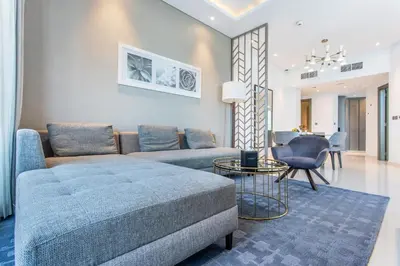 a living room with a couch and a table at The S Holiday Homes Canal view Studio and One Bedroom Apartments, Damac Maison Prive in Dubai