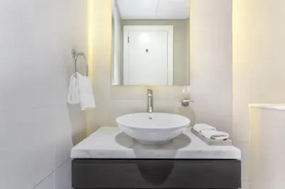 a bathroom with a bowl sink on a counter at The S Holiday Homes Canal view Studio and One Bedroom Apartments, Damac Maison Prive in Dubai