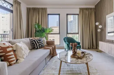a living room with a couch and a table at GuestReady - Luxe Arabian Apartment in Downtown in Dubai
