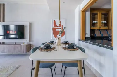 a dining room with a white table and chairs at GuestReady - Luxe Arabian Apartment in Downtown in Dubai