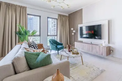 a living room with a couch and a tv at GuestReady - Luxe Arabian Apartment in Downtown in Dubai