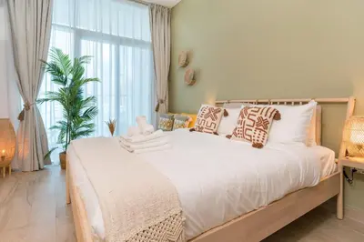 a bedroom with a large bed with a large window at Stunning Apt Marina view with Balcony in Dubai