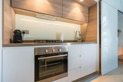 a kitchen with a stove and a counter top at Stunning Apt Marina view with Balcony in Dubai