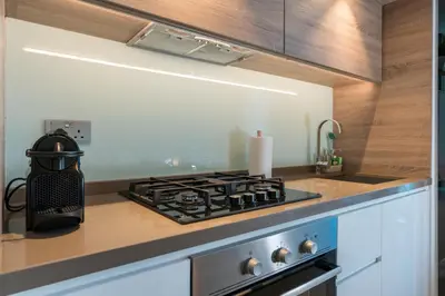 a kitchen with a stove top oven next to a counter at Stunning Apt Marina view with Balcony in Dubai