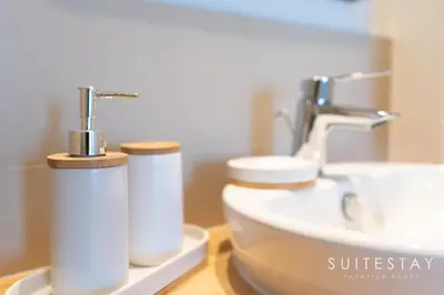 a bathroom with a toilet and a sink at Chic One Bedroom Suite with Cozy Interiors in Dubai