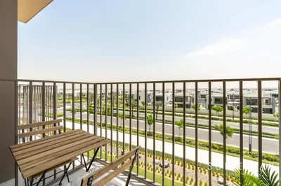 a balcony with a bench and a view of a street at Chic One Bedroom Suite with Cozy Interiors in Dubai