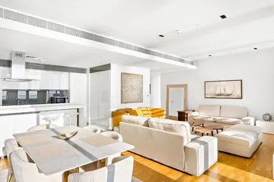 a living room with white furniture and a table at Phenomenal 2BR with Scenic Sea-View from ALL rooms! in Dubai