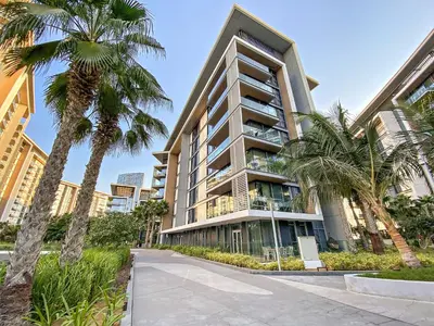 a tall building with palm trees in front of it at Phenomenal 2BR with Scenic Sea-View from ALL rooms! in Dubai