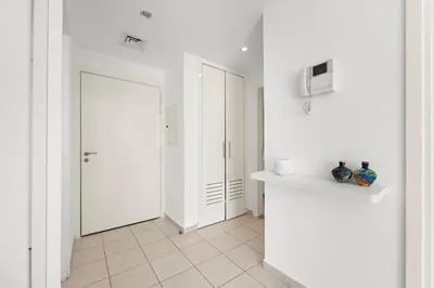 a room with white walls and a white hallway at Charming 1BR in The Greens, Near Metro in Dubai