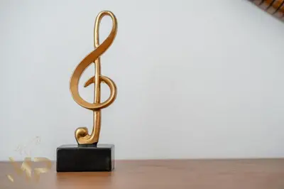 a bronze sculpture of a treble clef on a table at Marco Polo - Wake up to breathtaking Burj Khalifa views in Dubai