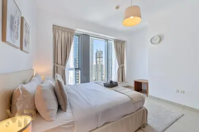 a bedroom with a large bed with a large window at Marco Polo - Wake up to breathtaking Burj Khalifa views in Dubai