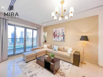 a living room with a couch and a table at Mira Holiday Homes - Lovely 1 bedroom in Downtown in Dubai