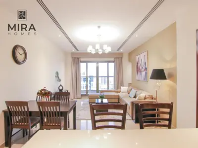 a living room with a couch and a table at Mira Holiday Homes - Lovely 1 bedroom in Downtown in Dubai