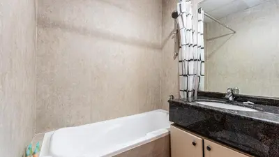a bathroom with a sink and a bath tub at Cosy 1 Bedroom Marina Apartment in Dubai