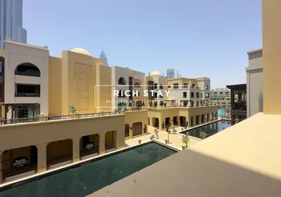 a view of a building with a swimming pool at Upgraded 1BR in Downtown with Burj Khalifa View in Dubai