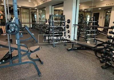 a gym with lots of equipment in a building at Upgraded 1BR in Downtown with Burj Khalifa View in Dubai