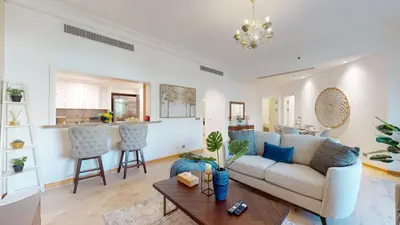 a living room with a couch and a table at Elegant 2 BR Apartment with Beach Access in Dubai