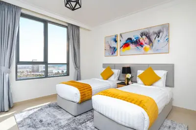 two beds in a room with two windows at Ultimate Stay / 7 people / Spacious / Dubai Creek with Marina Views in Dubai