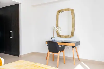 a bedroom with a desk with a chair and a mirror at Ultimate Stay / 7 people / Spacious / Dubai Creek with Marina Views in Dubai
