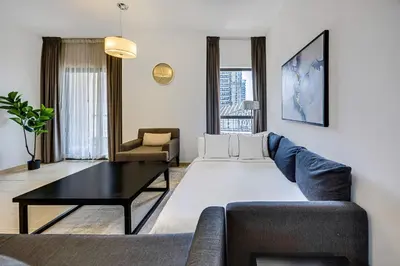 a living room with a couch and a table at Comfy 1BD family apartment in Shams JBR in Dubai